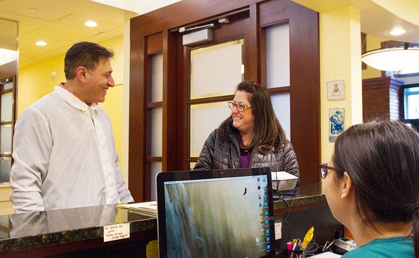 Dr. Carpinito and receptionist talking with a patient