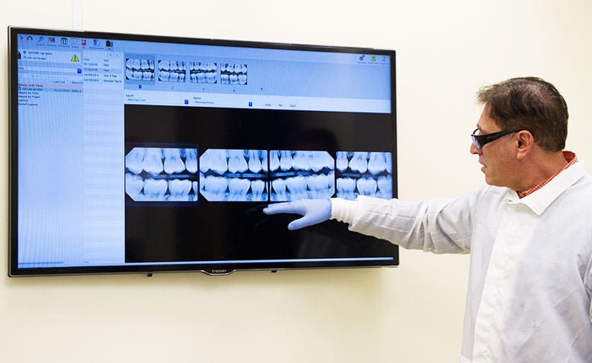 Dr. Carpinito looking at dental x rays